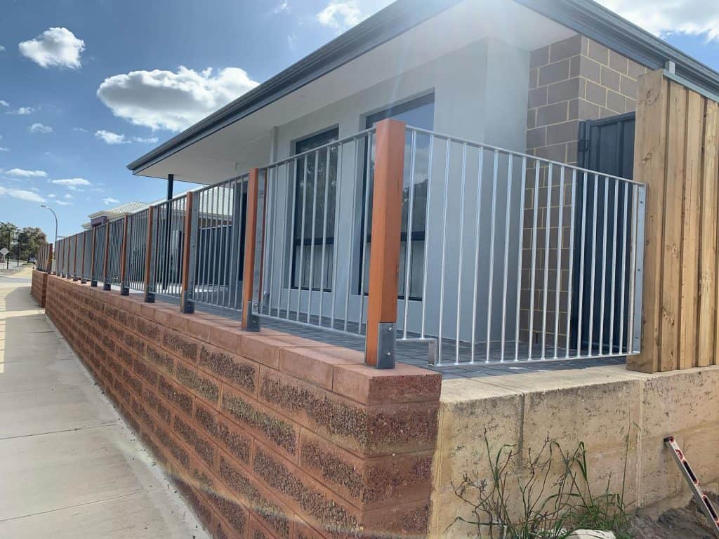 Wrought Iron Fencing with Timber Posts.